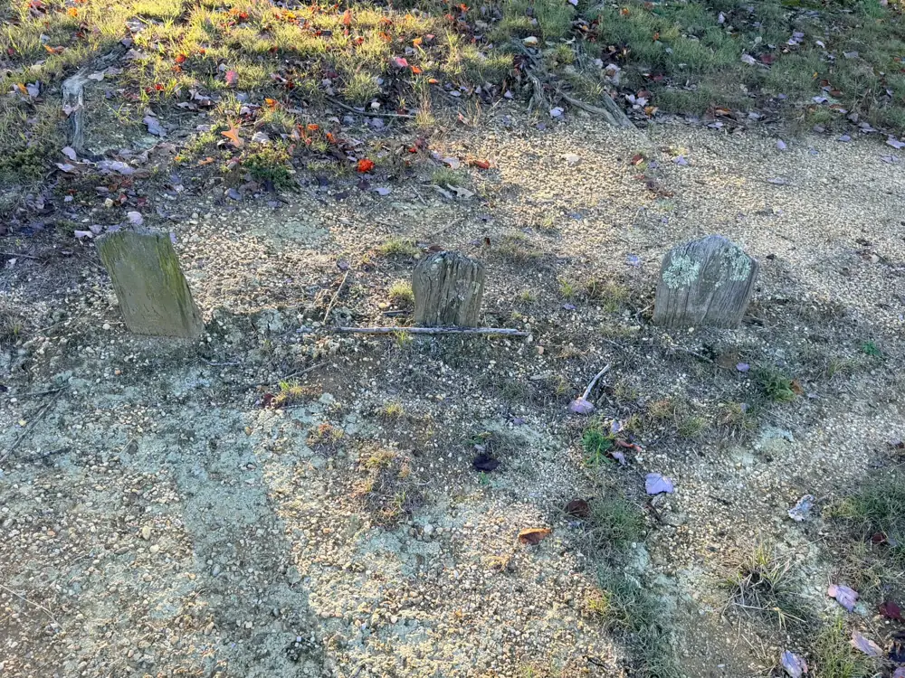Three small, weathered early grave markers with lichen at Mt. Calvary Cemetery